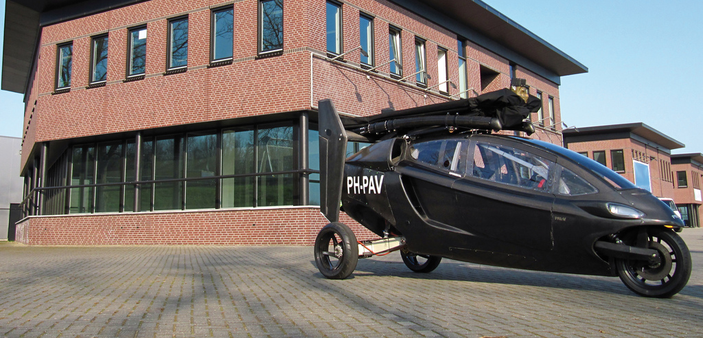Side view of Pal-V in front of brick building.